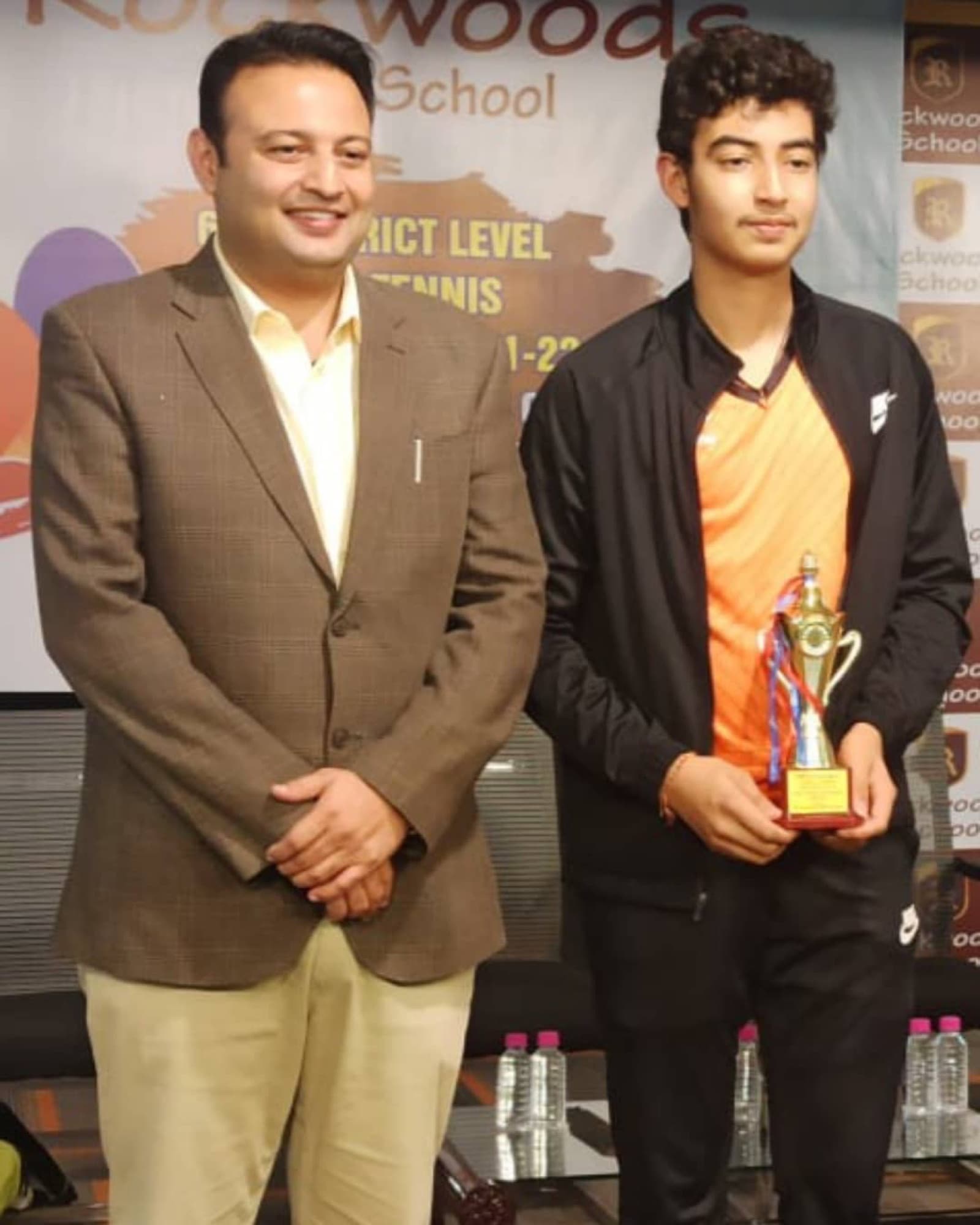 Pradhyuman receiving a district-level table tennis trophy
