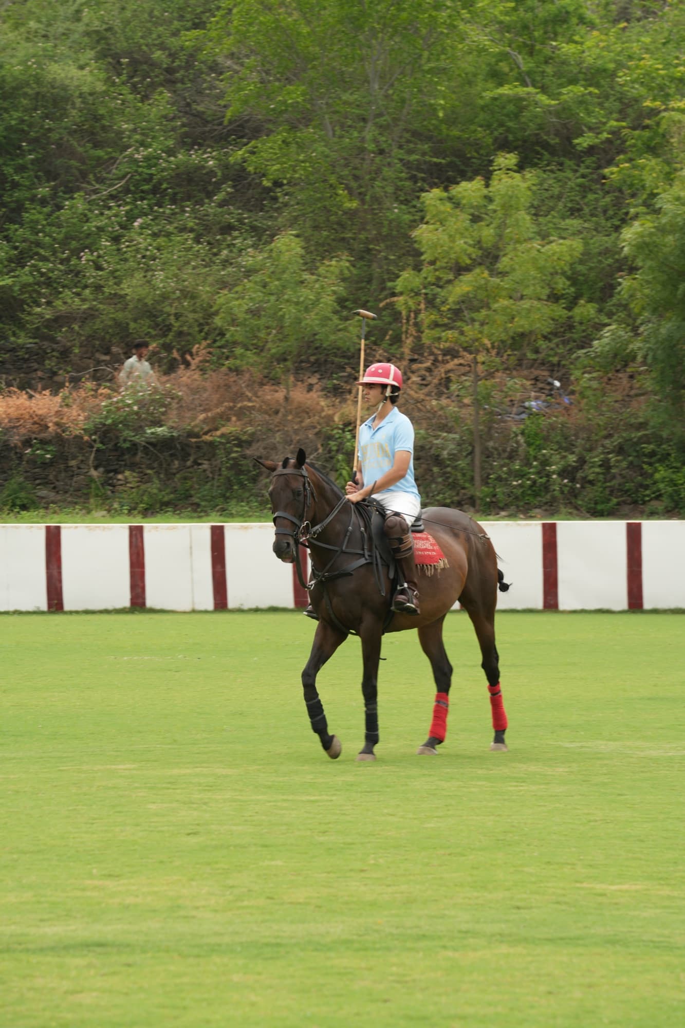 Pradhyuman Singh Hiran on horseback, mallet raised, mid polo match